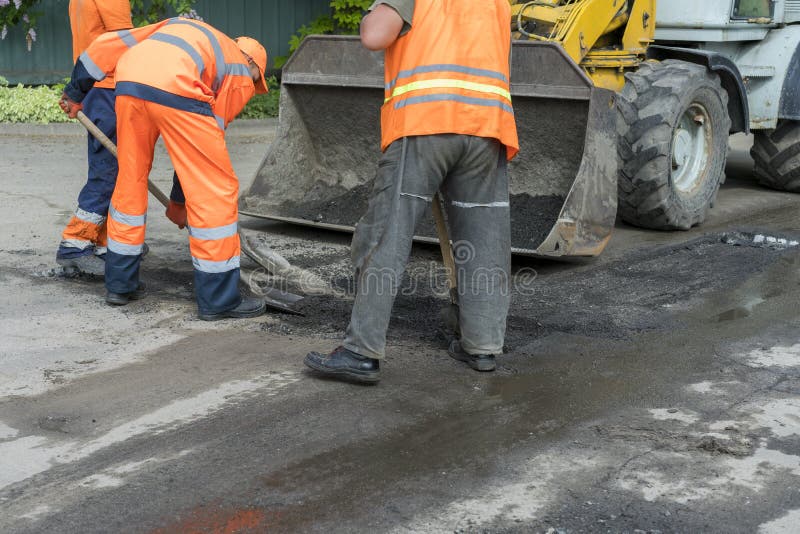 Workers on a road construction, industry and teamwork. builders workers at asphalting paver machine during Road street royalty free stock photo Workers on a road construction, industry and teamwork. builders workers at asphalting paver machine during Road street royalty free stock photo