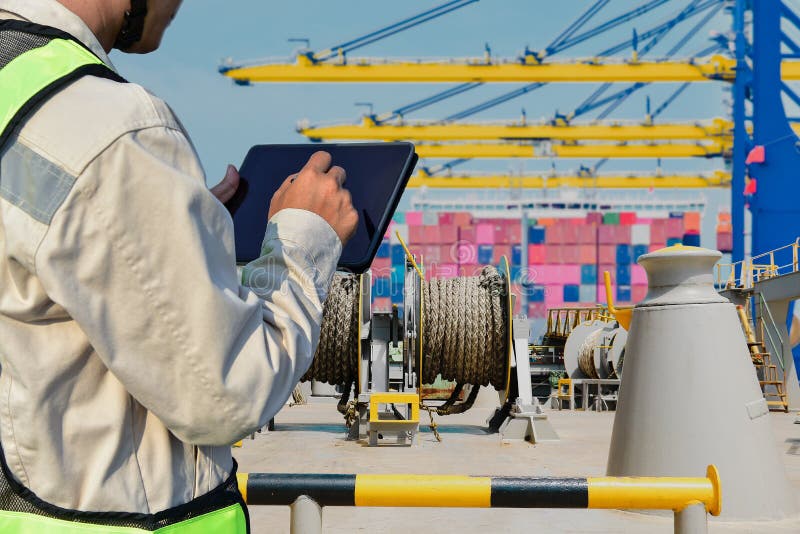 Worker hand holding tablet in port