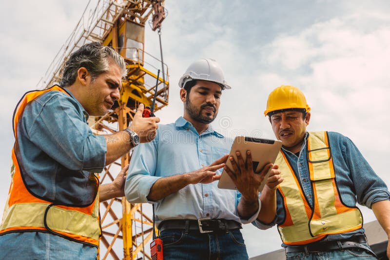 Workers team working together with contractor at construction site. Engineer project teamwork people concept stock photo