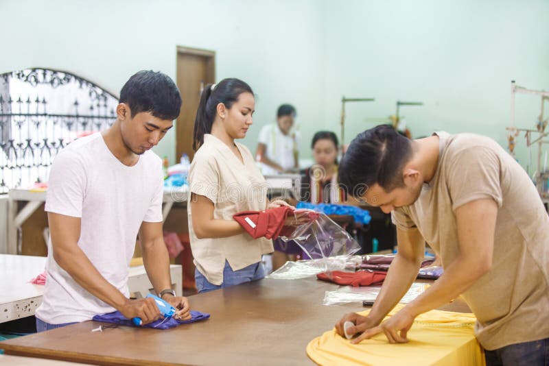 Workers at Textile Company Marking a Fabric, Labelling, and Pack Stock