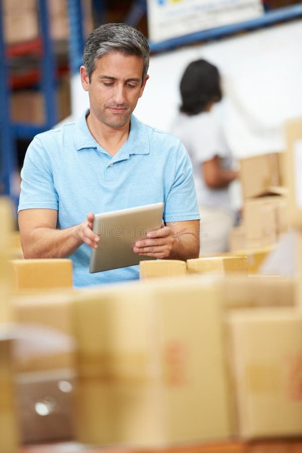 Workers In Warehouse Preparing Goods For Dispatch