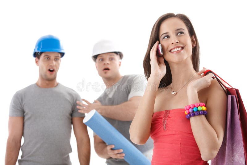 Workers watching attractive woman stock photos Workers watching attractive woman stock photos
