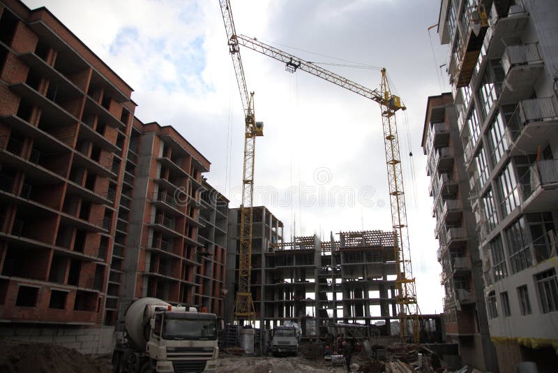 Working crane on the construction of the house. Construction of a residential multi-storey building.