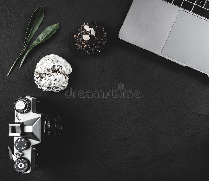 Working desk of a photographer, camera, laptop keyboard, break sweets and milk coffee, top view royalty free stock photos Working desk of a photographer, camera, laptop keyboard, break sweets and milk coffee, top view royalty free stock photos
