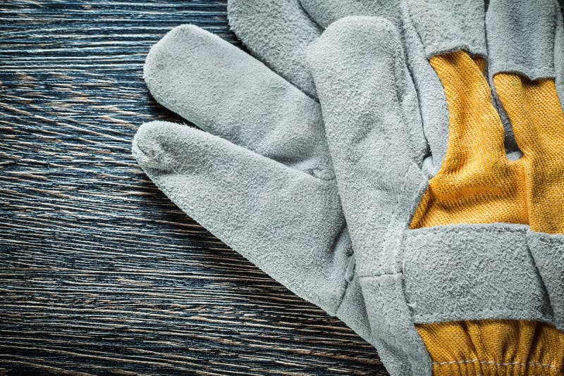 Working gloves on wooden board top view. Pair working gloves stock images, royalty-free photos and pictures