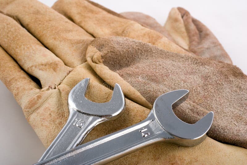 Working gloves and wrench metal tools on white background. Pair working gloves stock images, royalty-free photos and pictures