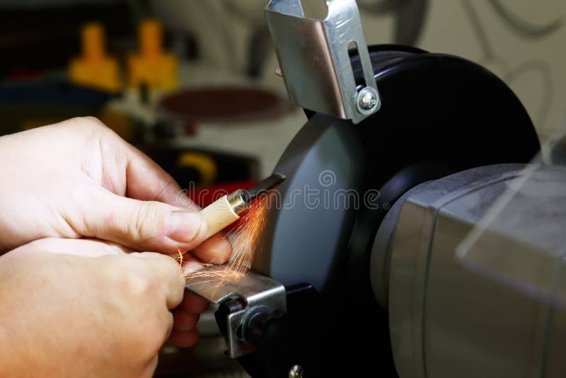 Working on the grinding machine stock photography