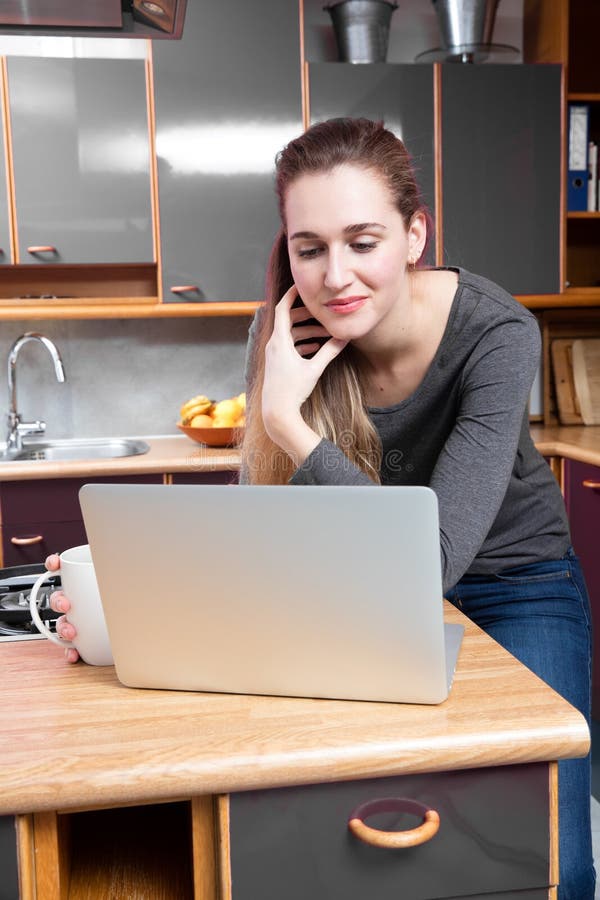 Working home concept - thinking young beautiful woman reading on laptop royalty free stock image Working home concept - thinking young beautiful woman reading on laptop royalty free stock image