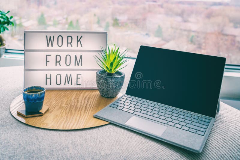 Working from home remote work inspirational social media lightbox message board next to laptop and coffee cup for COVID