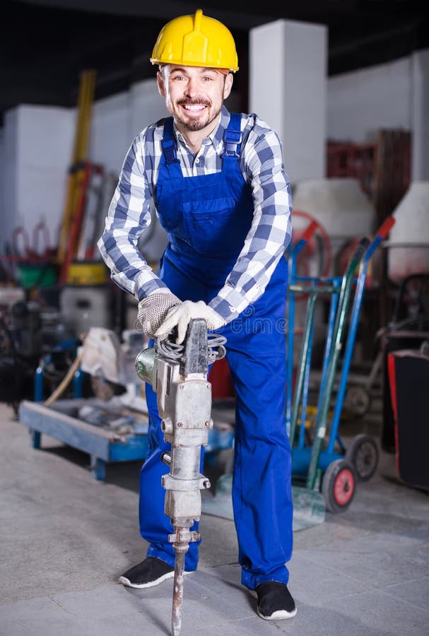 Working Man Practicing His Skills with Pneumatic Drill at