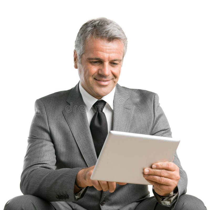 Happy smiling mature businessman surfing the net and working with digital tablet isolated on white background. Happy smiling mature businessman surfing the net and working with digital tablet isolated on white background
