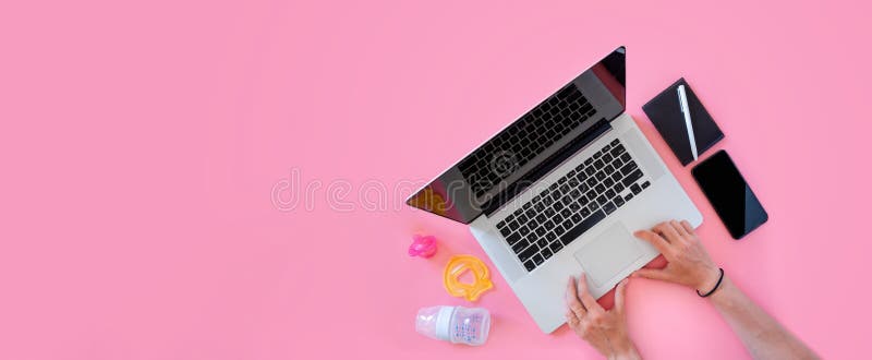 Working mom top view flatlay of workplace baby items and laptop with phone stock photography Working mom top view flatlay of workplace baby items and laptop with phone stock photography