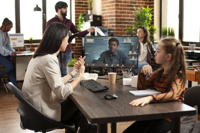 Working mother conducts online videocall stock photos