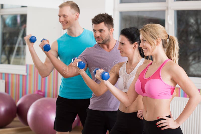 Group Of Smiling People Working Out With Dumbbells Stock Image - Image