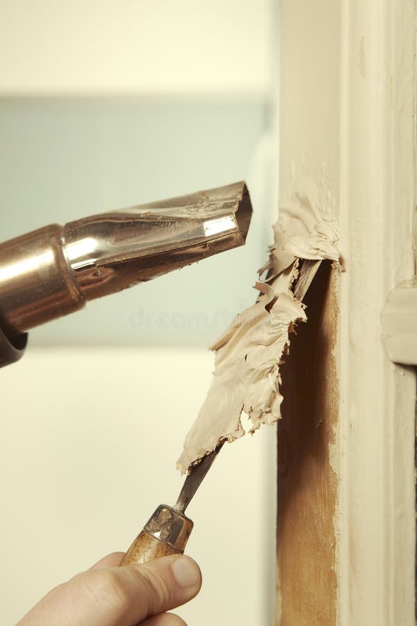 Working on Paint Removing from Indoor Home Door Frame Stock Photo