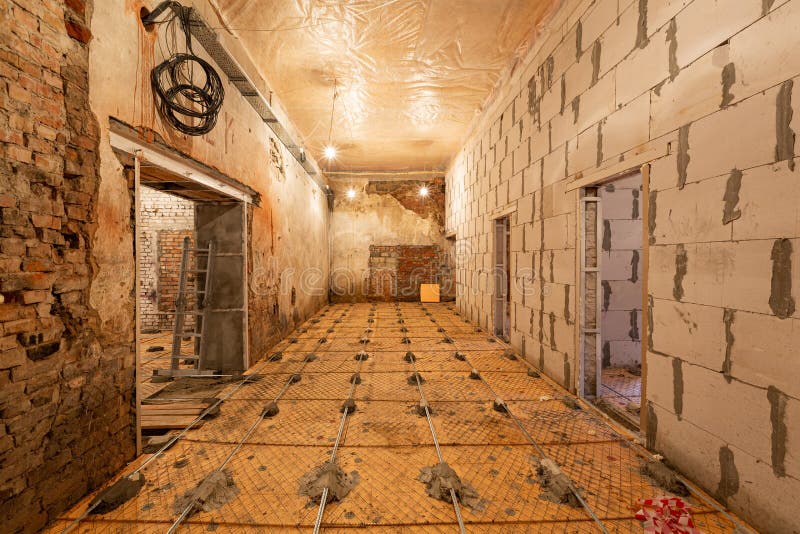 Working process of building house with wall made from foamed concrete blocks and floor prerared for pouring by cement stock images