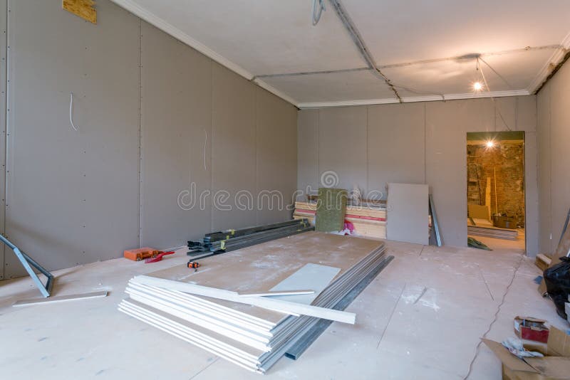 Working process of installing metal frames for plasterboard drywall for gypsum walls in apartment is under constructio royalty free stock images