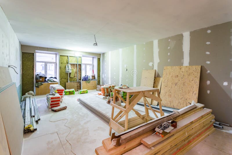 Working process of installing metal frames for plasterboard -drywall - for making gypsum walls in apartment is unde royalty free stock photo