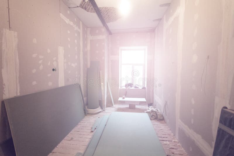 Working process of installing metal frames for plasterboard drywall for making gypsum walls in apartment is under construction stock images