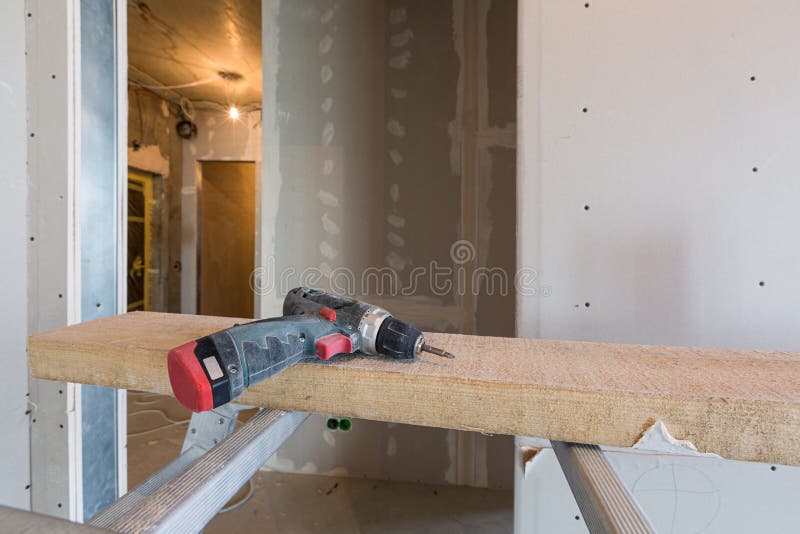 Working process of installing metal frames for plasterboard -drywall - for making gypsum walls in apartment is under stock images