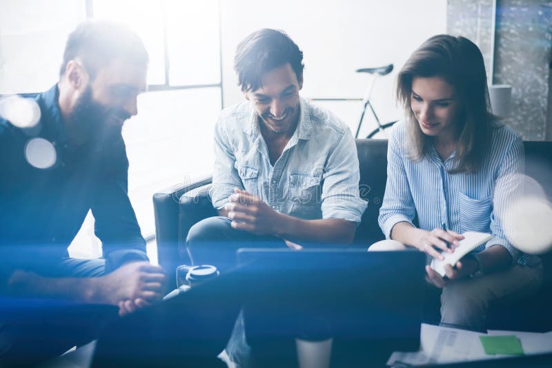 Working process photo.Group of young coworkers working together at sunny modern office loft.Teamwork concept.Blurred stock image Working process photo.Group of young coworkers working together at sunny modern office loft.Teamwork concept.Blurred stock image