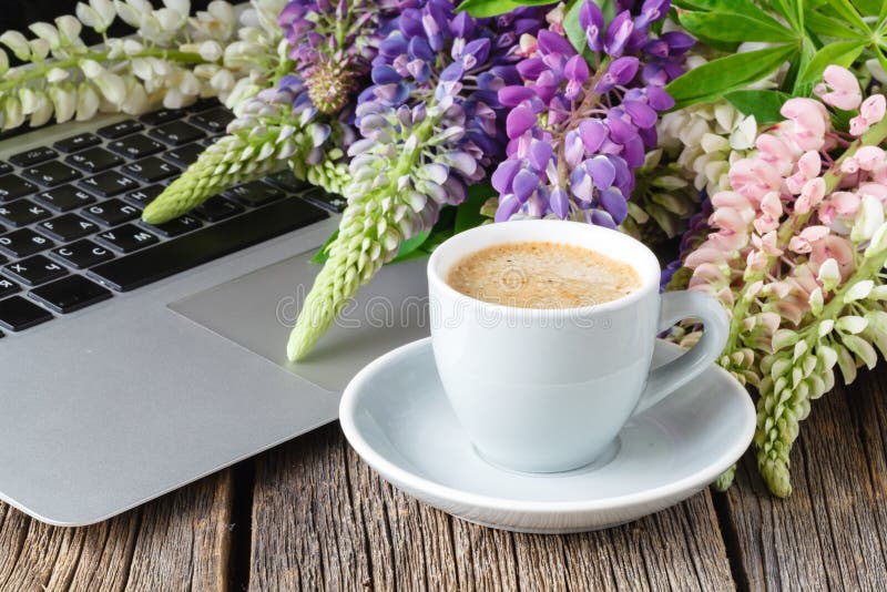 Working space or working place with laptop, flowers and coffee