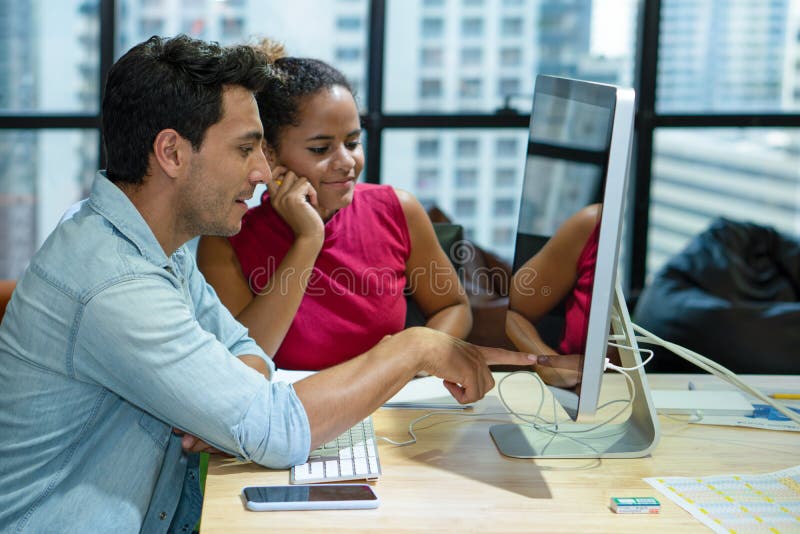 Working couple happy with working together in office with computer