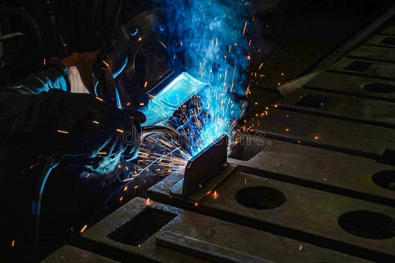 The Working Welder Performs Welding Work in Production Using Electric Arc Metal Welding Stock