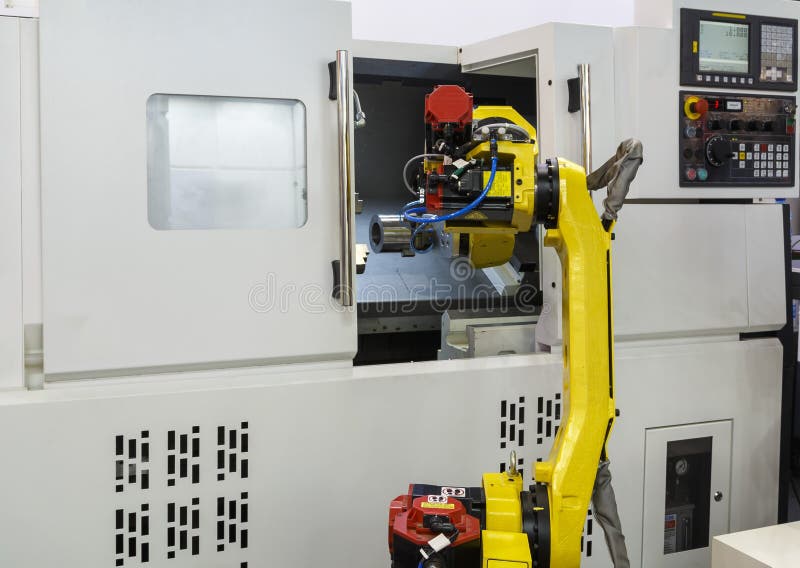 Working yellow robotic hand and CNC machine royalty free stock images