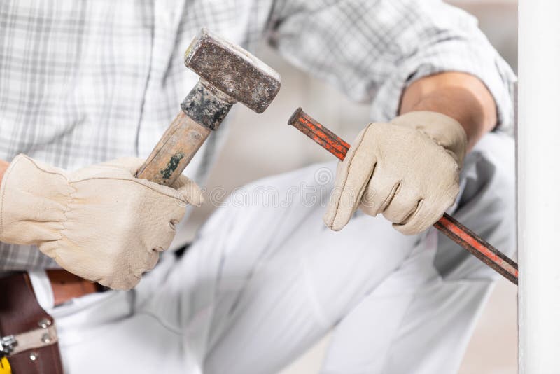 Workman or builder using a mallet and chisel royalty free stock photography