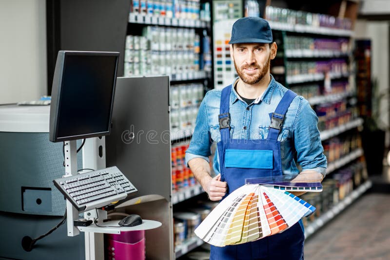 Workman with color swatches in the building shop stock images Workman with color swatches in the building shop stock images