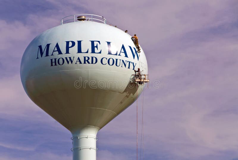 Workmen painting a modern water tower