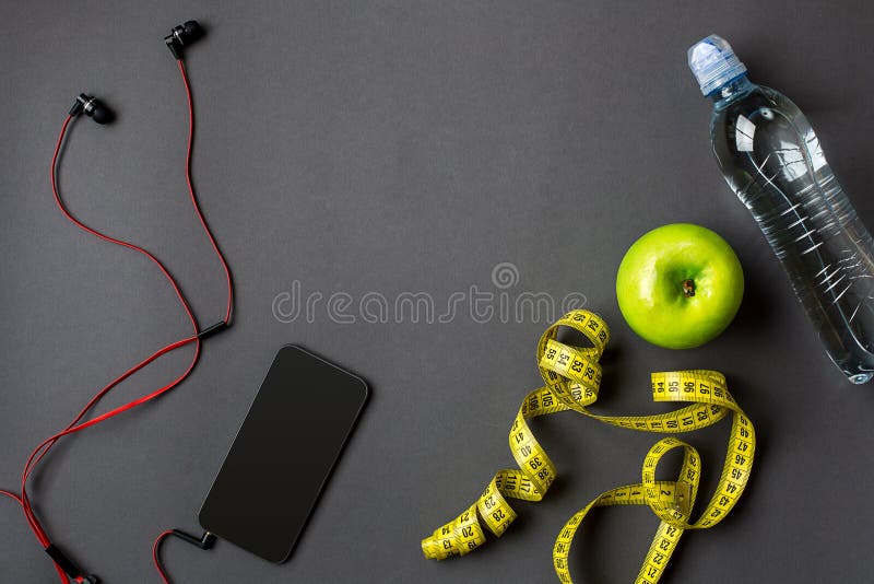 Workout plan with fitness food and sport equipment on gray background, top view. Copy space. Still life. Workout plan with fitness food and sport equipment on gray background, top view. Copy space. Still life