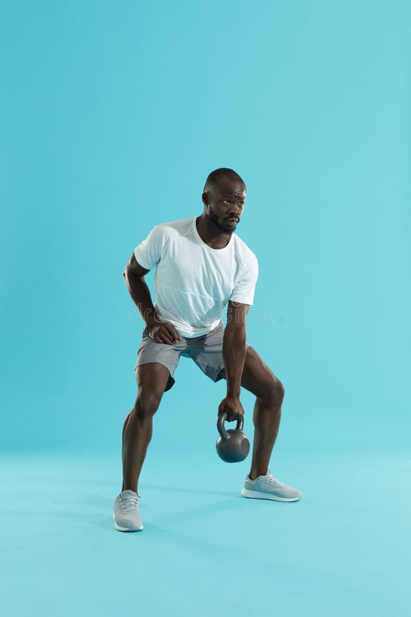 Workout. Sports man doing kettlebell exercise training