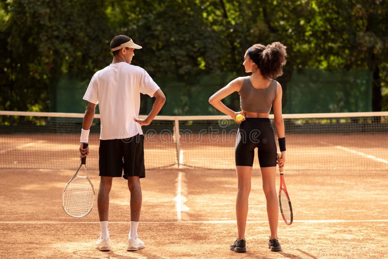 Two young people having a workout at tennis court royalty free stock images