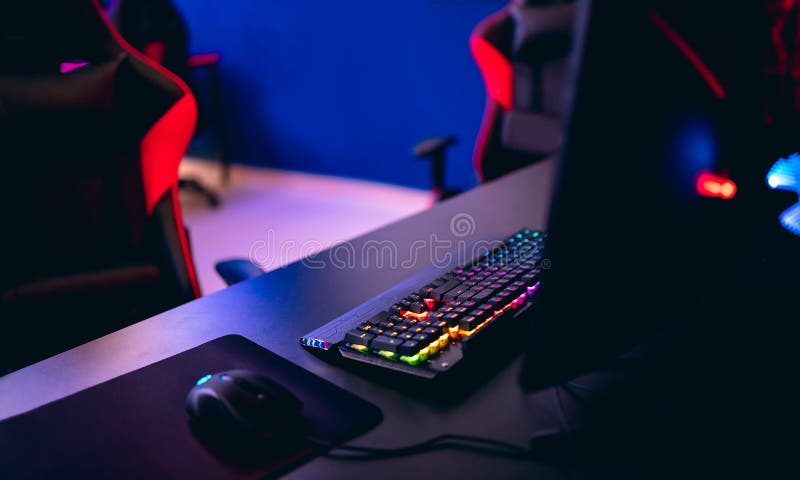Workplace for professional gamer in computer games, online tournaments, comfortable chair, backlit keyboard, monitors