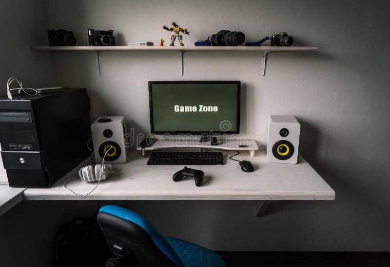 The workplace of a professional gamer with a monitor, gamepad, headphones and an armchair