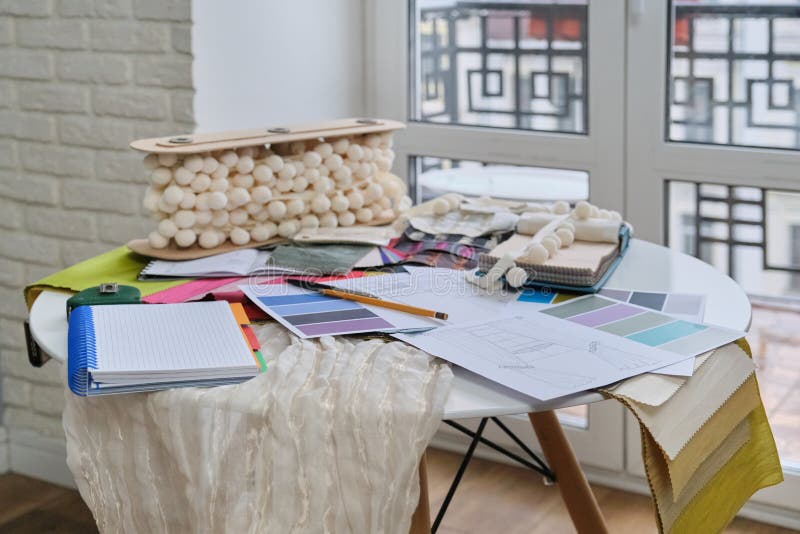 Workplace of textile designer, on the desk palettes with fabrics
