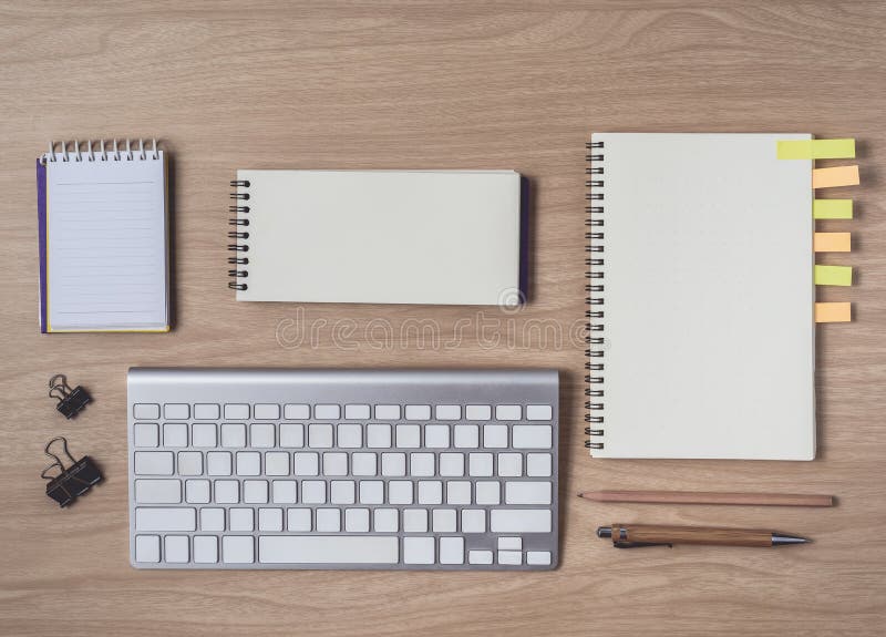 Workspace with diary or notebook and clipboard, keyboard, pencil, sticky notes on wooden background royalty free stock image Workspace with diary or notebook and clipboard, keyboard, pencil, sticky notes on wooden background royalty free stock image