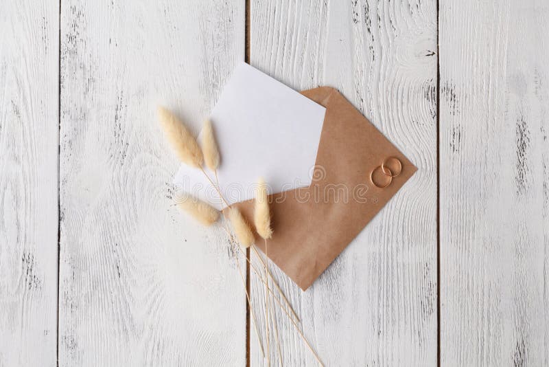 Workspace with laptop, handmade invitation lists, craft envelope, pen, twine, candles and watercolor paintings on white background royalty free stock photo Workspace with laptop, handmade invitation lists, craft envelope, pen, twine, candles and watercolor paintings on white background royalty free stock photo