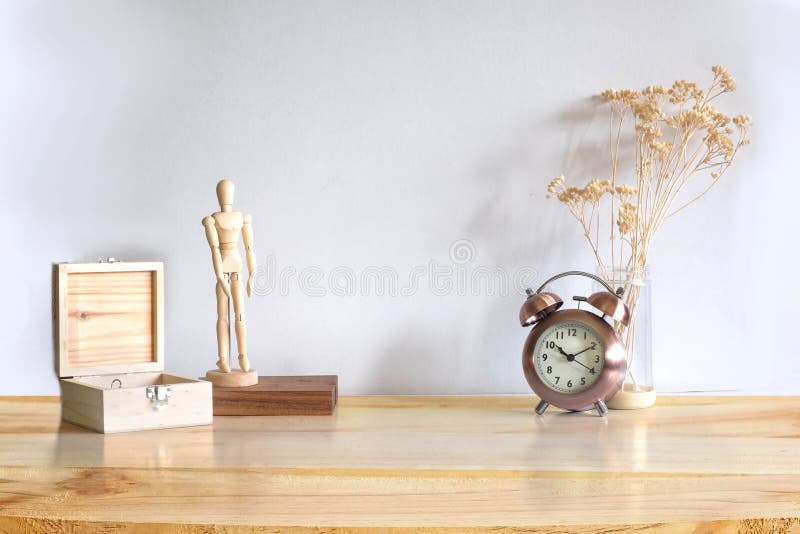 Workspace wooden object box, model wooden toy, alarm and dry plant on wood table.