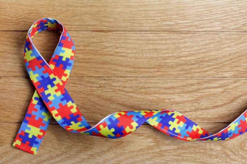 Sensibilizarea publicului la nivel mondial și mândria, zi sau lună, cu o panglică de tipar pentru puzzle pe fond de lemn. stock images
