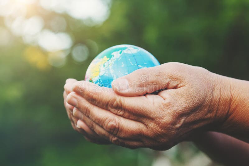 Senior woman`s hands holding earth globe royalty free stock image