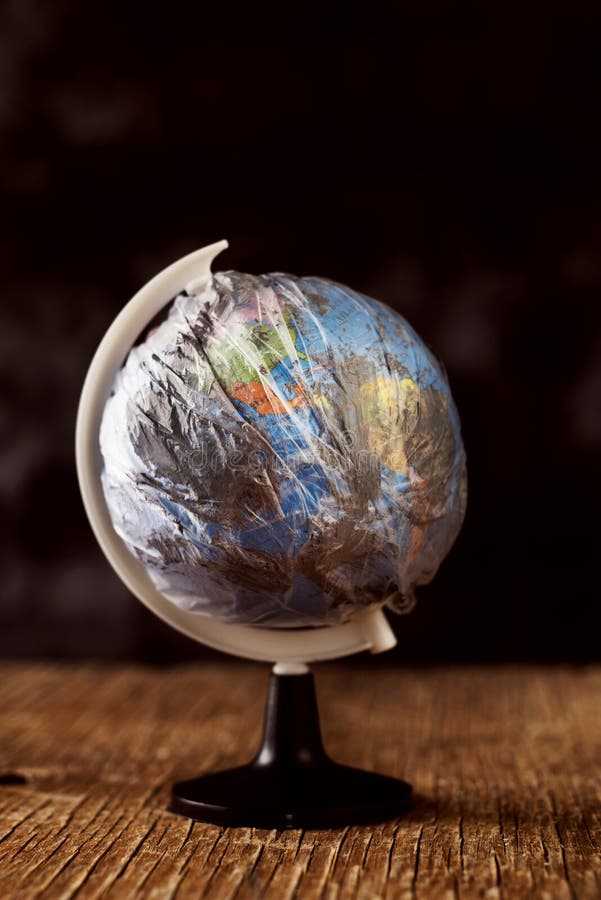 World globe wrapped in a dirty plastic royalty free stock photography World globe wrapped in a dirty plastic royalty free stock photography
