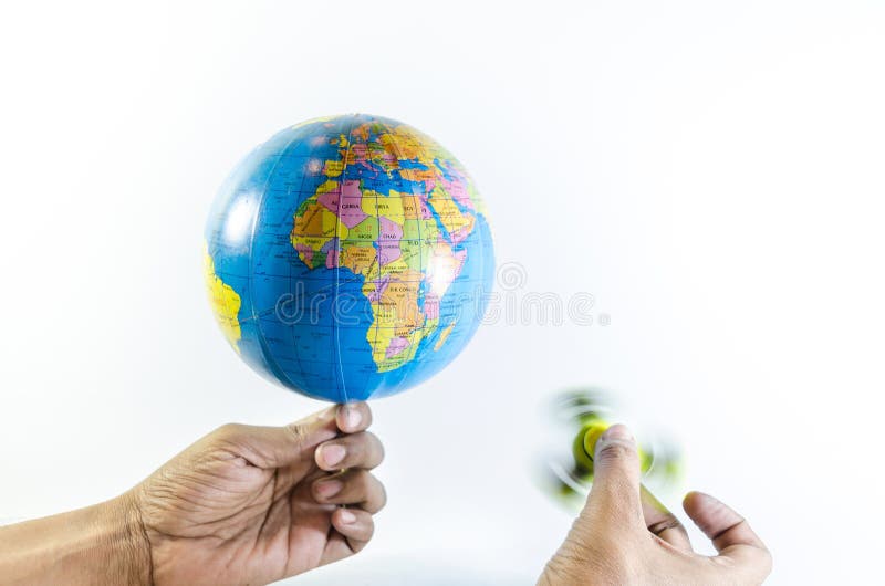 World is spinning and fidget spinner is spinning holding by hand stock illustration
