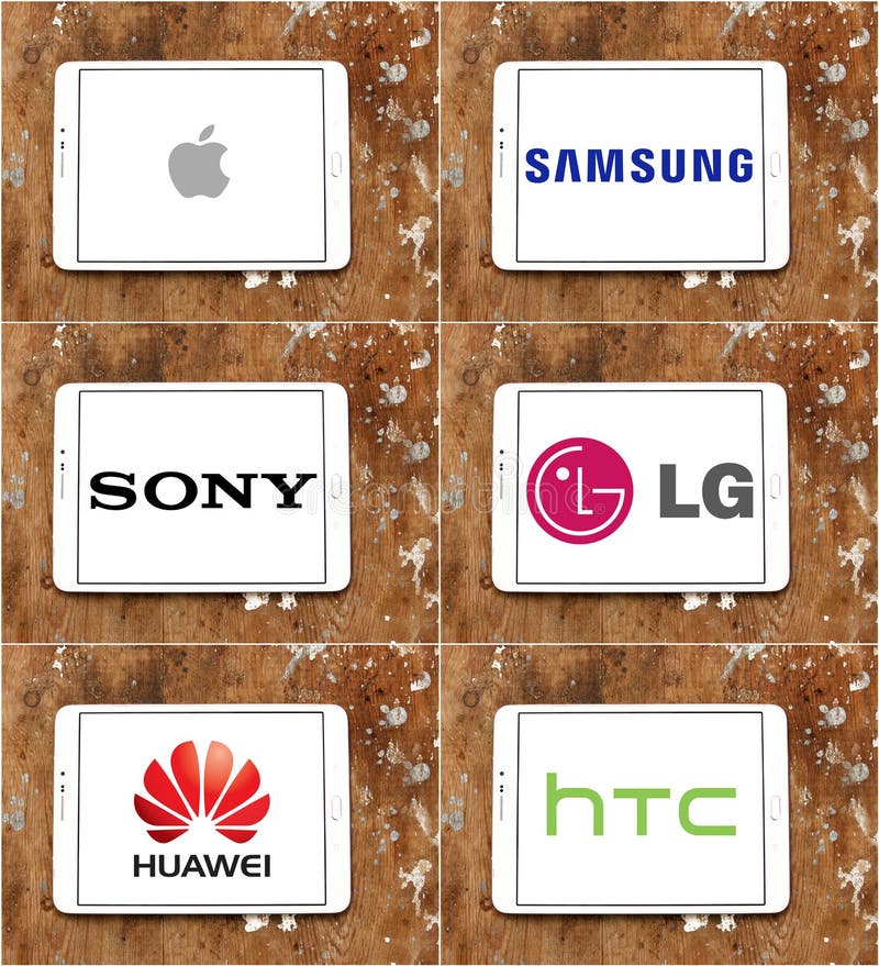 Logos and brands of worldwide smartphone and technology brands apple , samsung , sony , lg , huawei , htc on white tablet on rusted wooden background