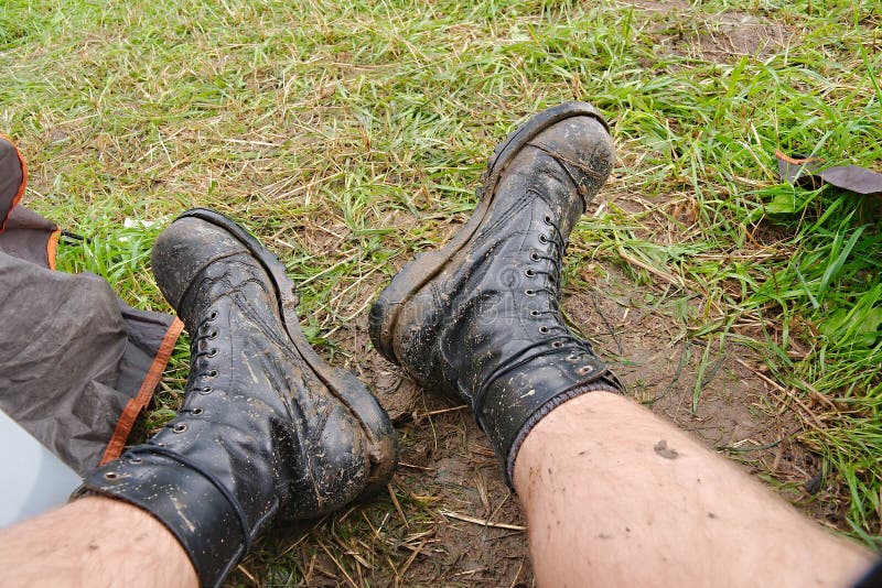 Steel cap boots covered in mud in a festival camp. Steel cap boots covered in mud in a festival camp