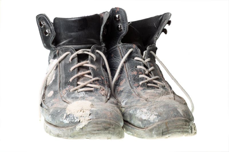 Worn-out old work boots, isolated on white.