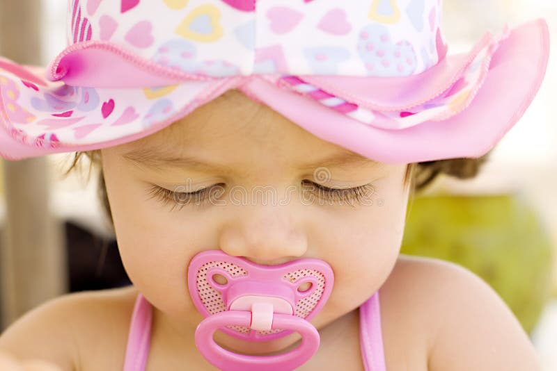 Worried baby girl with dummy