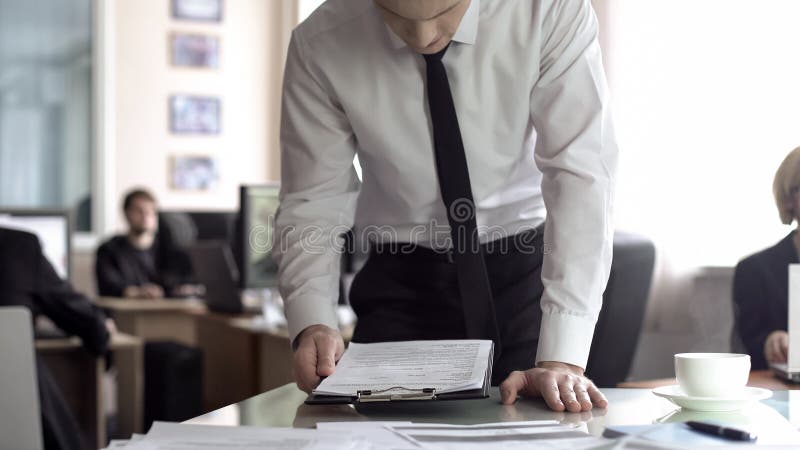 Worried businessman reading contract, upset by loss of company revenue, report royalty free stock image Worried businessman reading contract, upset by loss of company revenue, report royalty free stock image